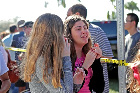 Students released from a lockdown are overcome with emotion following following a shooting at Marjory Stoneman Douglas High School in Parkland, Fla.,