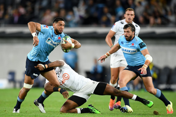 Losing cause: Curtis Rona tries to break the Sharks defence.