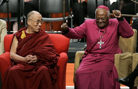 The Dalai Lama, left, looks on as Archbishop Desmond Tutu, of South Africa, does an impromptu dance move after remarking that his wireless microphone made him feel like pop star Michael Jackson, during an event at the University of Washington in Seattle. The event took place on the final day of a five-day visit by the Dalai Lama to Seattle centered around the theme of "Seeds of Compassion."