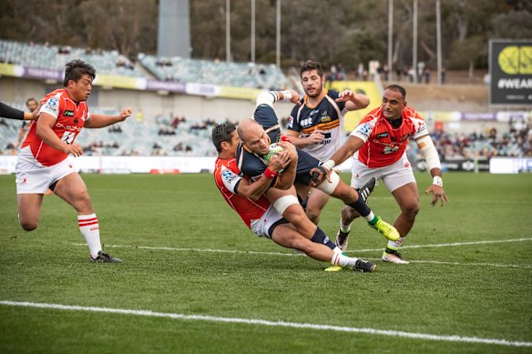 Brumbies flanker Lachlan McCaffrey is brought down short of the try line.