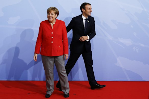 German Chancellor Angela Merkel and French President Emmanuel Macron upon his arrival at the G20.