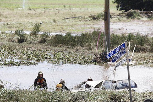 Emergency services search for bodies in the town of Grantham, in the Lockyer Valley, which was devastated by a sudden flood on January 10. Photo: Dean Saffron