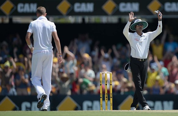 Stuart Broad of England walks back to his mark after being hit for six by David Warner.