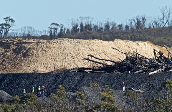 EPA and mine staff inspect a spill of coal waste and water from the Clarence Colliery coal mine into the Wollangambe River, near Lithgow.
