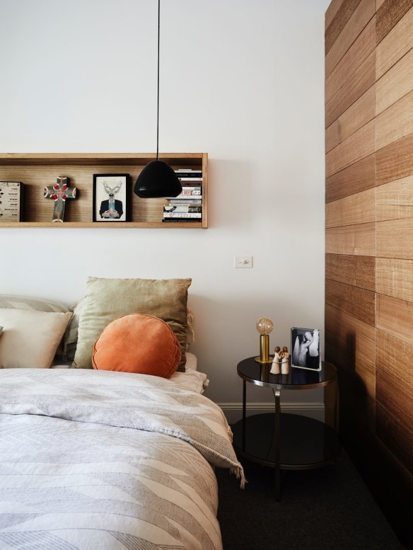 In the master bedroom, a new wall was built in Tasmanian oak, in keeping with the aesthetic of the home’s addition. The black pendant light is by Melbourne designer Ross Gardam.