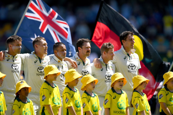 Arm in arm: Australian players before the start of play in the Brisbane Test last summer.