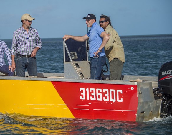 Prime Minister Tony Abbott - with indigenous Apudthama Land and Sea Ranger Wilfred Namai (driving - right) and Indigenous Affairs Minioster Nigle Scullion (left) on their way to the mouth of the Jardine River on Cape York on Friday 28 August 2015.