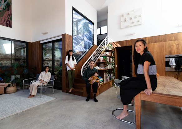 Architect Qianyi Lim (in black) with her partner Ross Paxman, daughter, Linya, mother Kooiying Mah and sister Xinyi Lim inside Stable House, which she designed. The house is built in old stables at the rear of another property so that the generations can all live close together. 