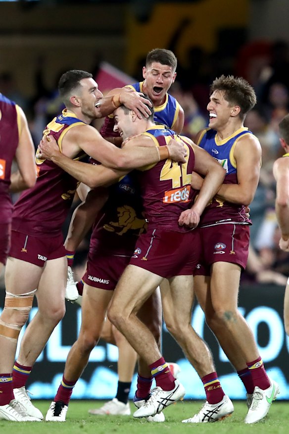 Lion James Madden is swarmed by his Lions teammates after a goal.