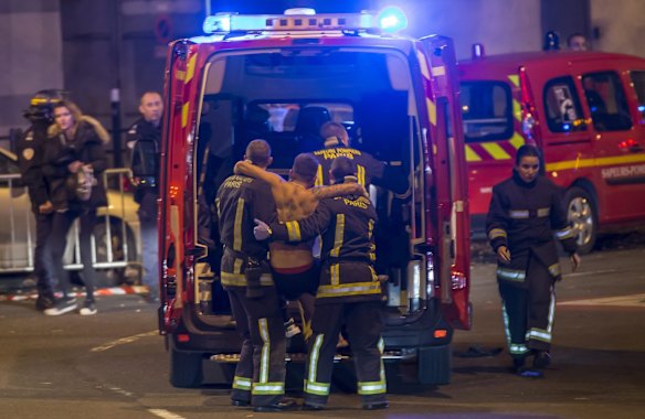 Wounded people are evacuated from the Stade de France in Paris after explosions were reported. At least 26 people have died in attacks in Paris on 13 November after reports of a shootout and explosions near the Stade de France stadium.