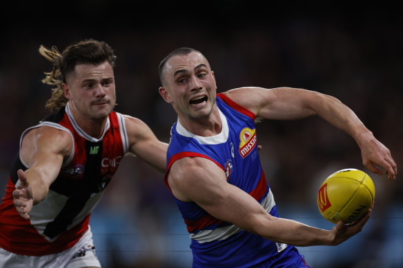 Under the pump: Bulldog Toby McLean had little time to make a clean disposal against the Saints.