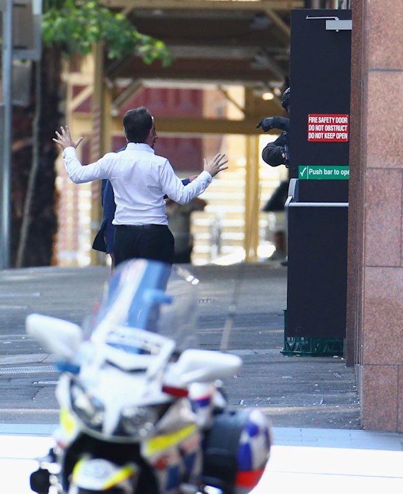Two hostages run to safety outside the Lindt Cafe, Martin Place.