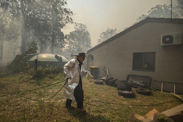 Taree South resident Carl Silver prepares for an out of control bushfire to impact his property along Glenthorne Road.