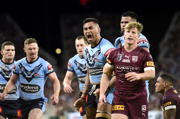 Daniel Saifiti of the Blues celebrates with team mates after scoring a try during game one.