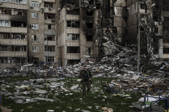 A Ukrainian serviceman walks amid the rubble of a building heavily damaged by multiple Russian bombardments near a frontline in Kharkiv, Ukraine.