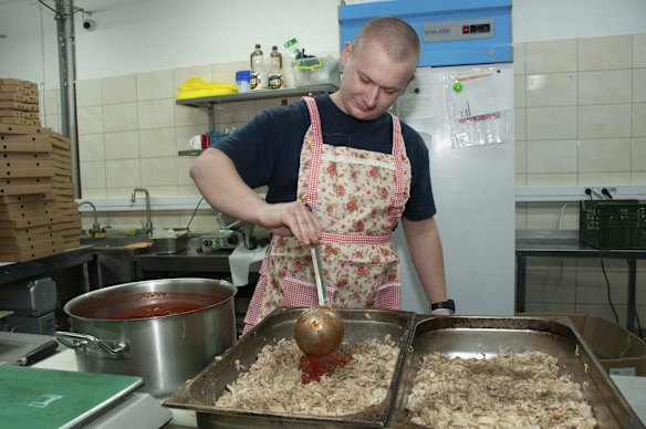 A volunteer cooks food for Ukrainian servicemen in Kharkiv.