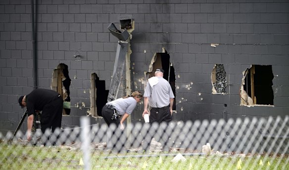 Police officials investigate the back of the Pulse nightclub. 