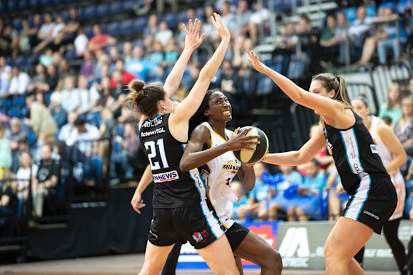Boomers' Ezi Magbegor tries to get through Capitals' Keely Froling and Lauren Scherf. 