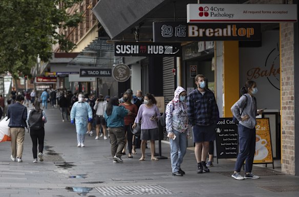 Sydneysiders queue for upwards of 2-3 hours to get a PCR test at a COVID testing site on George Street in Sydney's CBD on Tuesday, December 28, 2021.