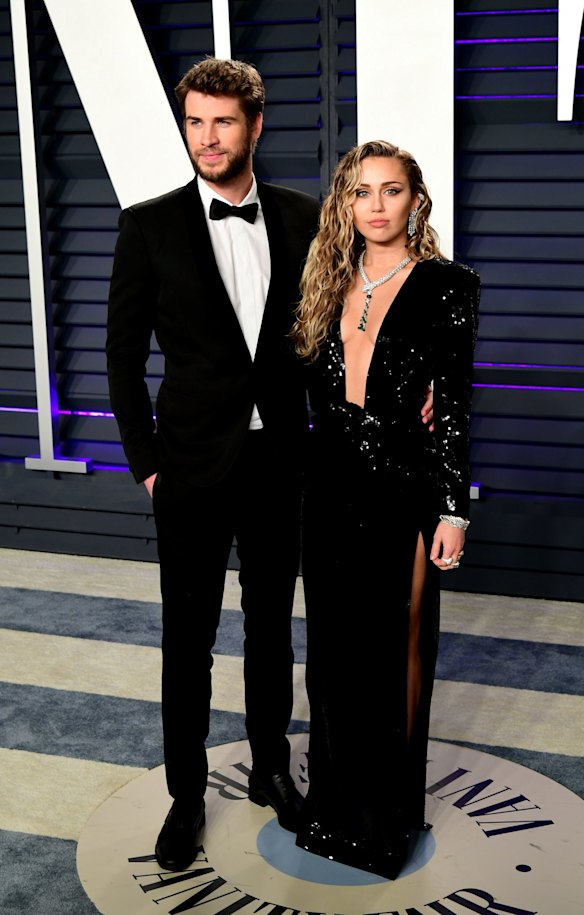 Liam Hemsworth (left) and Miley Cyrus arrive at the Vanity Fair Oscar Party in Beverly Hills, California.