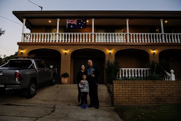 Rita, Elia and Joseph Fayad standing on their driveway to commemorate Anzac Day, in Beverley Hills.