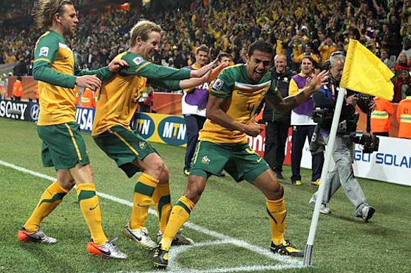 Tim Cahill celebrates his goal with teammates David Carney and Brett Holman.