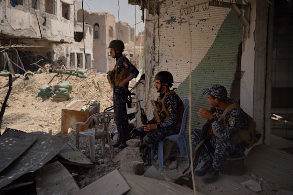 Iraqi soldiers at a firing position in West Mosul, on street where six IED's are yet to be cleared.
