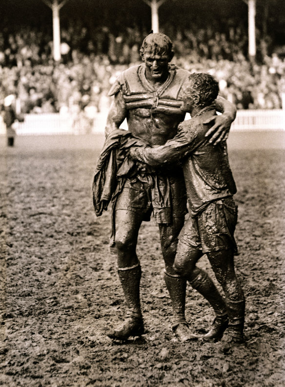 Norm Provan (St George) and Arthur Summons (Wests) leave a muddy SCG after the 1963 rugby league grand final.