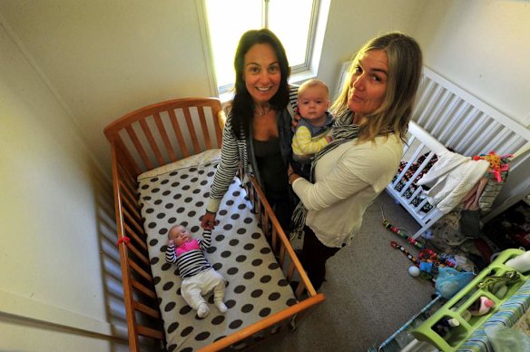 Canberra Capitals coach Carrie Graf, with partner Camille Chicheportische and baby twins Bentley (blue and yellow top) and Charli (blue and pink top).