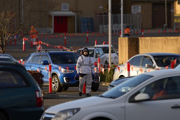 A medical worker is seen at the new 24-hour drive-through COVID-19 testing clinic at the Mounties Club car park in Mount Pritchard. New rules dictating that essential workers from the Fairfield LGA must be tested every three days if they are leaving the area come into force today. 17 July, 2021.
