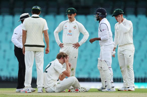 All-rounder Cameron Green goes down after being struck in the head while bowling at the SCG.