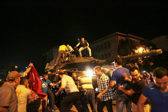Tanks move into position as Turkish people attempt to stop them. A loud explosion was heard in the capital, Ankara, fighter jets buzzed overhead, gunfire erupted outside military headquarters and vehicles blocked two major bridges in Istanbul.