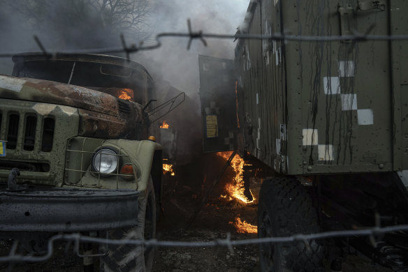 Ukrainian military track burns at an air defence base in the aftermath of an apparent Russian strike in Mariupol, Ukraine, Thursday, February 24, 2022. 