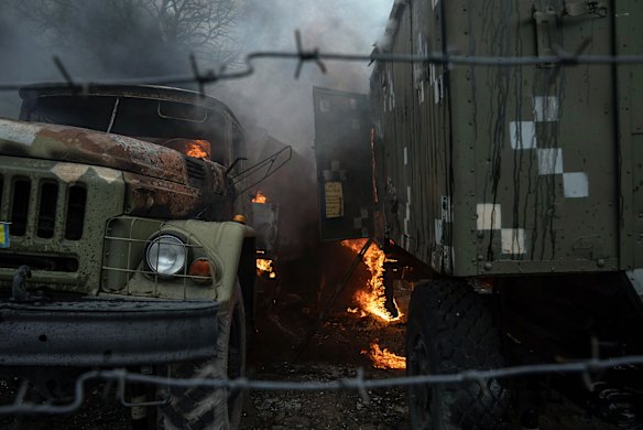 Ukrainian military track burns at an air defence base in the aftermath of an apparent Russian strike in Mariupol, Ukraine, Thursday, February 24, 2022. 