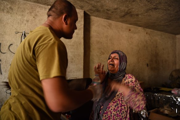 A woman overcome with shock is treated by medics in a field hospital in West Mosul.