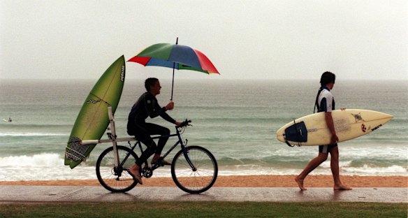 Surfers Adam Pagett and Will Dunlop looking for waves in the rain at North Steyne in 1999.