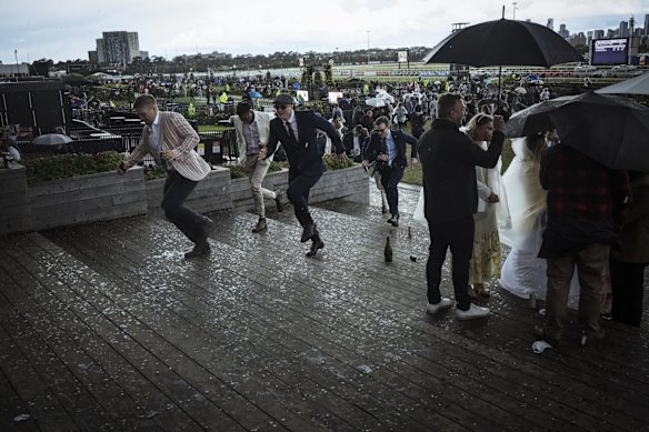 Punters seek shelter from the hail storm.