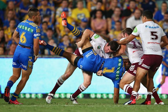 Jamie Lyon tackles Will Hopoate.