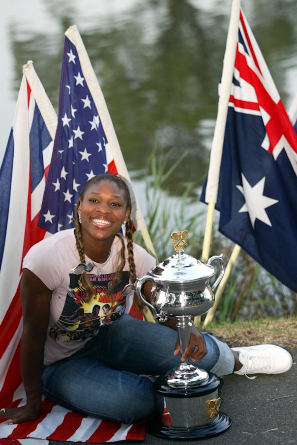 2003 Australian Open - Serena with the trophy along the Yarra River after her victory over Venus, Williams completed the 'Serena slam', holding all four major trophies at the same time.