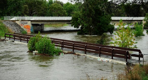 Floodwater in Ginninderra Creek flows under Ginninderra Drive near Charnwood.