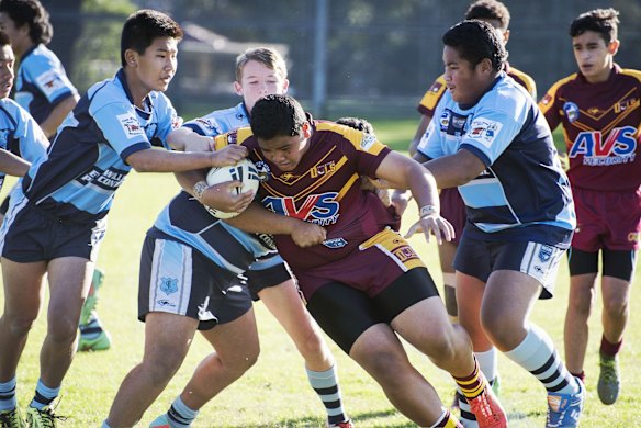 The Cabramatta forwards try to bring an Owls player to the ground.