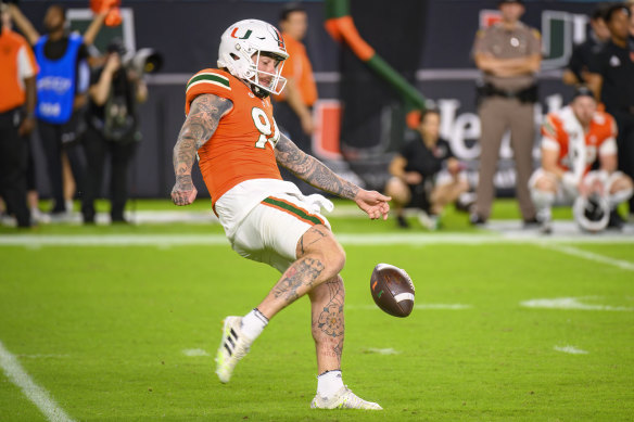 Lou Hedley punting for University of Miami in the no.94.