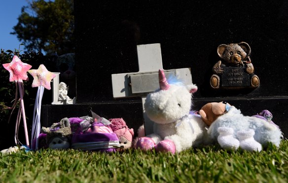 Trinkets and toys lay at the grave of baby Lily Grace who was found dead on Maroubra Beach in 2014. 