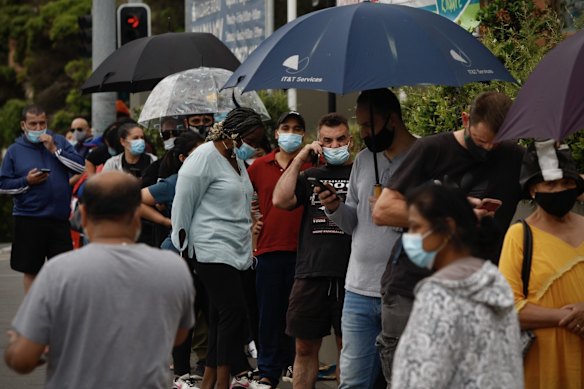 People queue at the Kildare Road Medical Centre in Blacktown for a COVID PCR test.