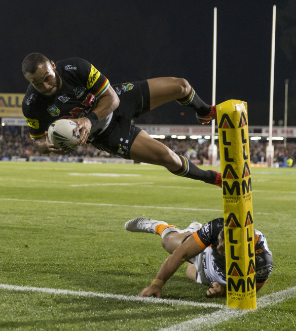 Flying winger: Penrith's Tyrone Phillips scores a spectacular try against the Tigers on Thursday night.