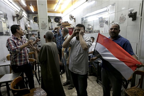 Egyptians celebrate at a tea house after President Mohammed Morsi was removed from power.