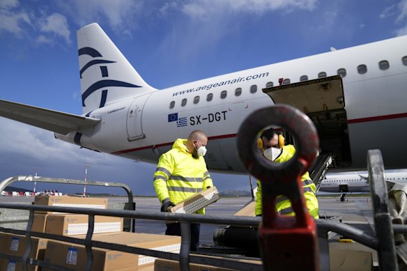 Airport workers prepare humanitarian aid at Eleftherios Venizelos International Airport in Athens. It was destined for Poland.