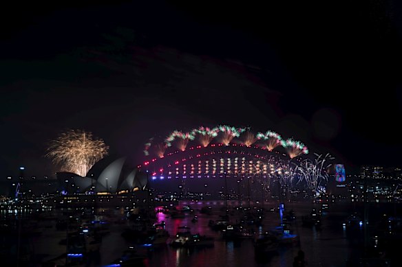 The New Years Eve Midnight fireworks light up the Sydney Harbour Bridge and Opera House.