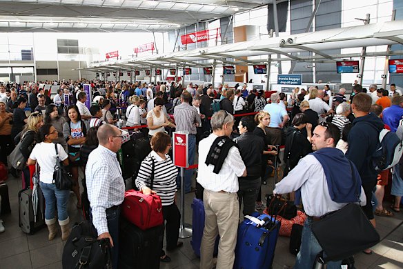 Long queues are seen at the Virgin Australia Domestic Terminal in Sydney on Sunday, after Qantas suspends flights.