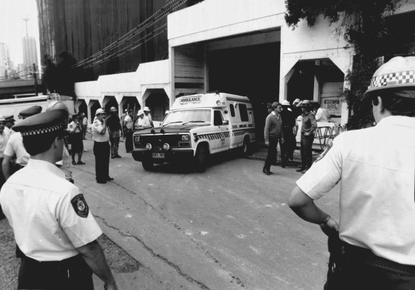 An ambulance departs the building site for Royal Prince Alfred Hospital.